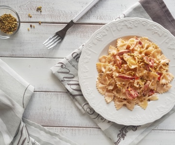 Farfalle à la crème de parmesan, speck et pistaches