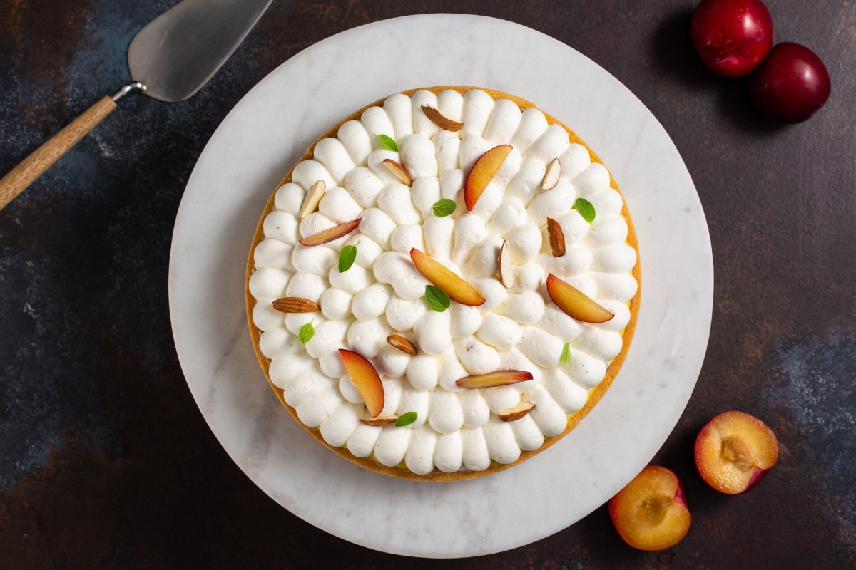 Tarte à la crème pâtissière aux amandes, chantilly et prunes