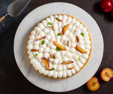 Tarte à la crème pâtissière aux amandes, chantilly et prunes